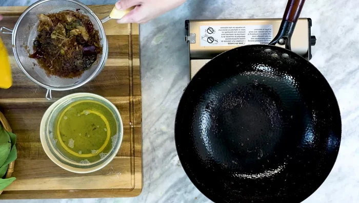 Strain the fried aromatics, reserving the oil. Discard solids.
