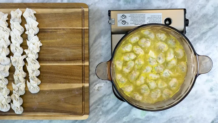 Add cold water to lower the temperature and allow the wontons to cook until they float to the surface.