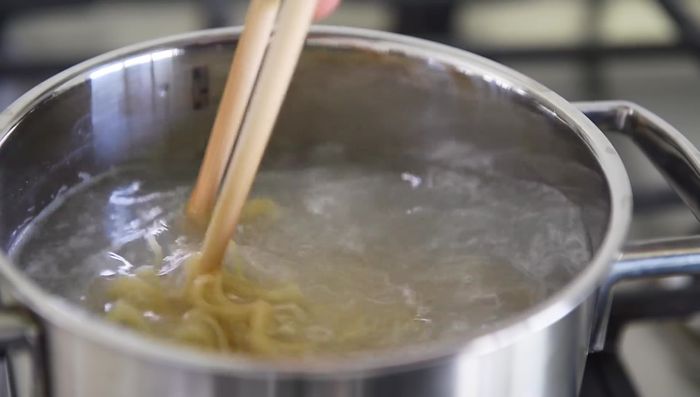 Reserve 1/4 cup of cooking water. Strain the noodles and set aside.