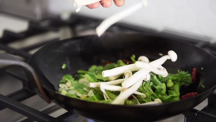 Add broccolini and seafood mushrooms, salt, and sauté for 2-3 minutes.