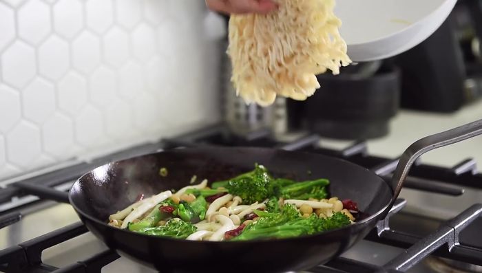 Add noodles and sauce to the pan. Stir-fry.
