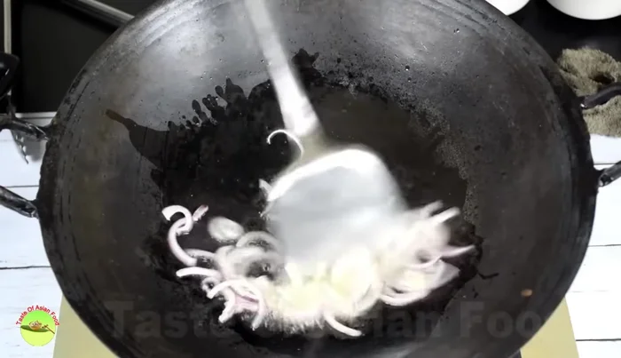 Sauté onions in vegetable oil, then add garlic and sauté until aromatic.