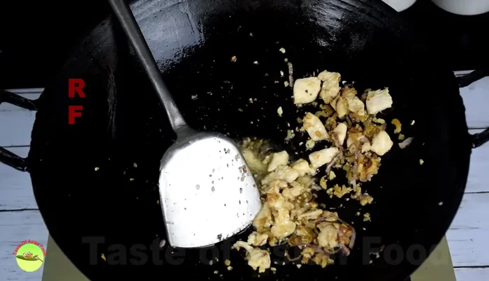 Add cabbage and carrots, cooking until soft. Push to the sides of the wok.