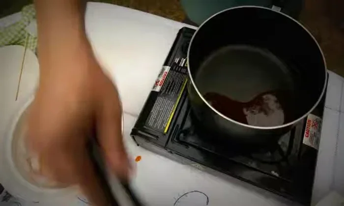 Toss the fried bananas in the hot toffee until fully coated.