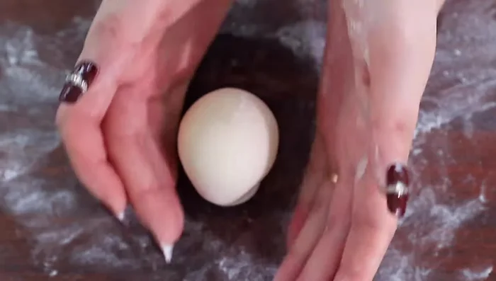 Roll the dough ball to make it taller. Repeat for all portions.
