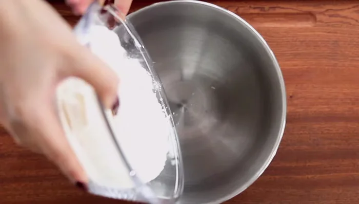 Pour yeast mixture into flour and knead with a stand mixer for about 1 minute.
