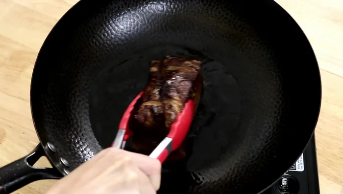Heat oil to 380°F. Fry pork skin-side down until the oil starts splashing, then cover immediately to prevent splattering. Fry each side for a couple of minutes on medium-low heat.