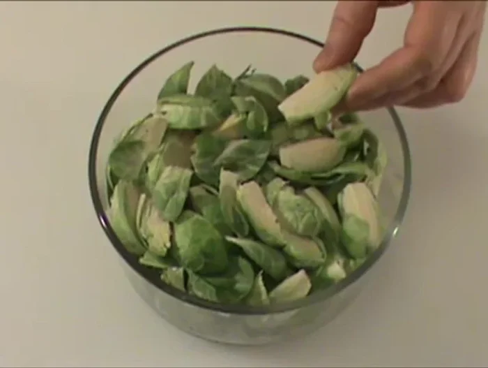 Cut 16 ounces of Brussels sprouts into quarters.