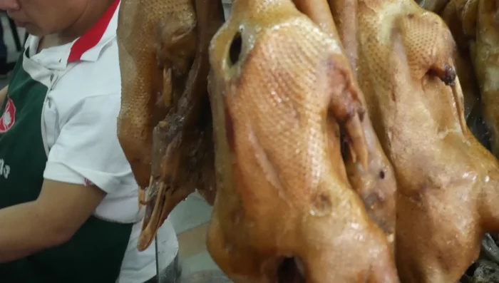 Cook the goose feet: Return the pot to the heat and let the goose feet cook until tender. (Specific cooking time is not provided in the transcript)