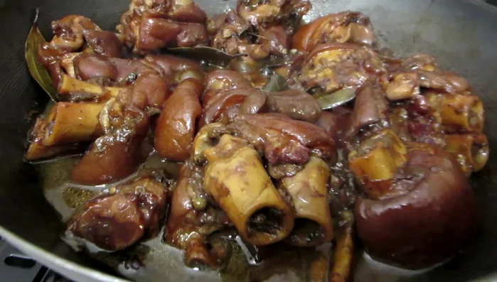 Check for doneness: Use chopsticks to check if the pig’s feet are cooked. The meat should easily separate from the bone.