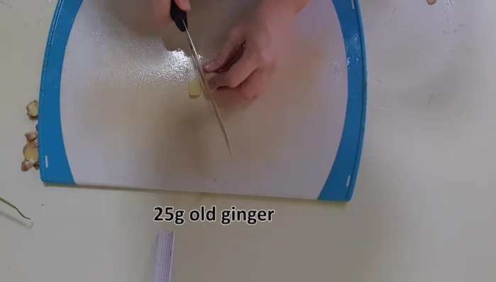 Peel and cut ginger into silken threads or thin slices. Peel and mince the garlic. Peel and cut shallots into thin slices.