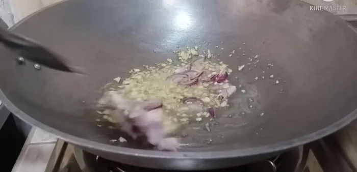 Add the marinated squid and stir-fry until cooked through.