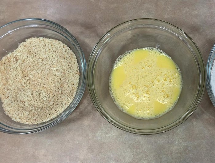 Bread the crab balls: flour, then egg, then breadcrumbs. Repeat until all are coated.