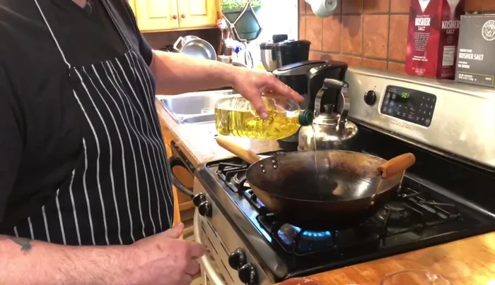 Heat grapeseed oil in a wok over high heat. Add minced garlic, ginger, and sliced scallions; stir-fry for about 30 seconds.