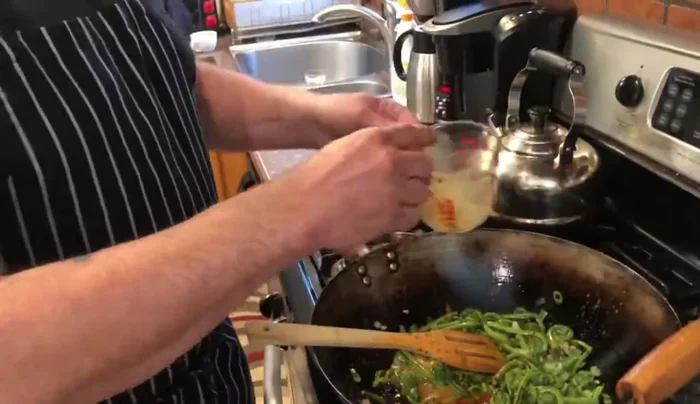 Pour the sauce over the fiddleheads and stir-fry until the sauce thickens and comes to a boil.