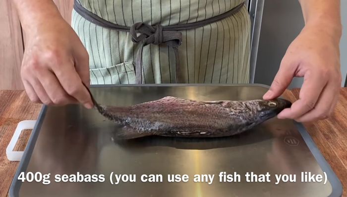 Butterfly the fish by scoring a cut along the bone, then carefully slice through the flesh until you reach the bones. Crack the ribcage to cut through completely.