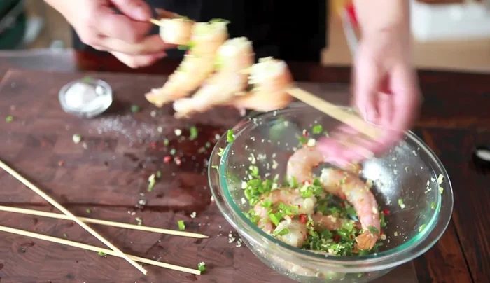 Skewer the shrimp (if desired). Use two skewers per shrimp to keep them flat for easier grilling.