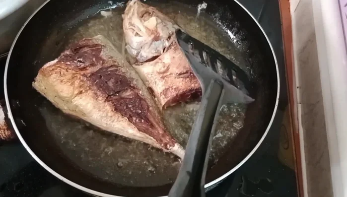 Add soy sauce, sugar, and water to the pan. Bring to a simmer and reduce heat to low. (Timings are not specified in the transcript)
