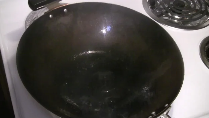 Add onions (optional) to the wok and stir-fry briefly.