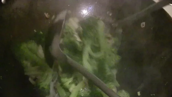 Add chicken broth (or water), black bean sauce, and stir-fry.