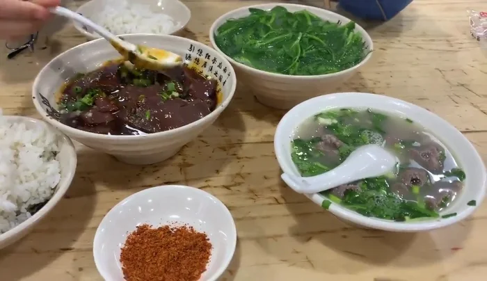 Combine pork, pork blood, and spices in a pot. (No specific instructions provided in the transcript)