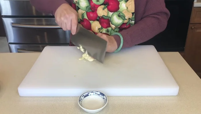 Crush the garlic.