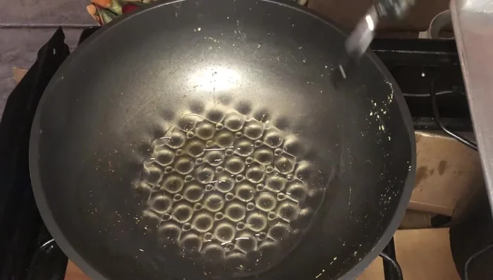 Add more oil to the wok, then add the black beans, jalapeno, and garlic. Cook to release the fragrance.