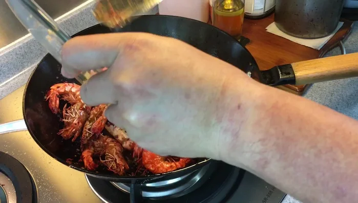 Add the fried prawns, 1 teaspoon of salt, and 1 teaspoon of sugar. Mix well and cook on medium heat until well combined.