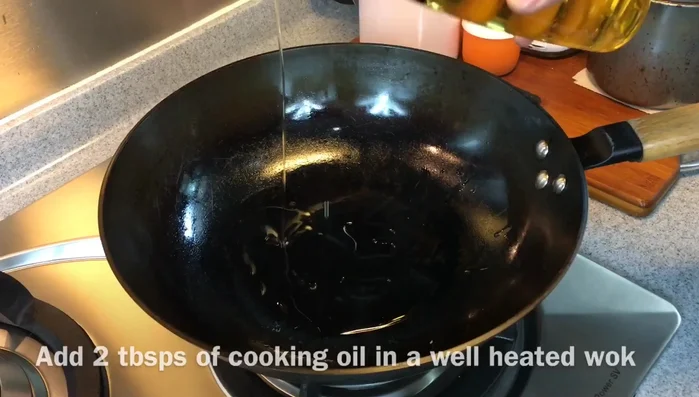 Heat a smoking hot pan with 2 tbsp of oil. Add chopped garlic and reduce heat to medium-low. Cook until light golden brown, stirring occasionally.