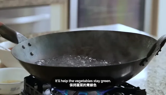 Add about 5 cups of boiling water to your wok (494.8).