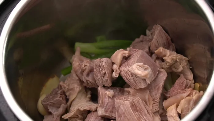 Add beef to the pot, ensuring it doesn't stick. Add prepared sauce and stir-fry for a few minutes.