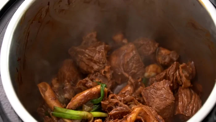 Add shaoxing wine, water, and spices (in a spice bag).