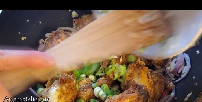 Add the baked chicken and spring onions to the pan.