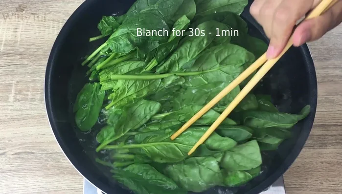 Blanch the spinach in boiling water for 30 seconds to reduce oxalic acid.