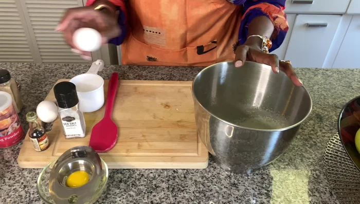 Add two whole eggs and one egg yolk, one at a time, beating well after each addition.