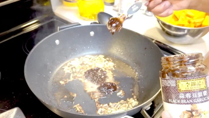 Add black bean sauce and pumpkin to the pan.