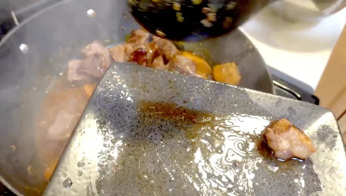 Add the beef back to the pan, along with green onions and oyster sauce.