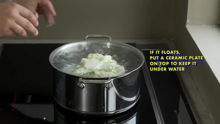 Place the whole cauliflower (stem-side up) in the boiling water and cook for 10-15 minutes, or until a fork easily pierces it.