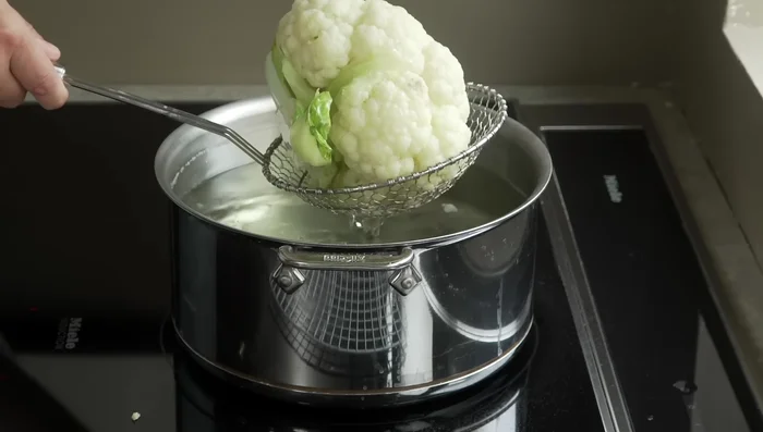 Remove the cauliflower using a spider strainer, letting excess water drip off. Place it on a wire rack to let steam evaporate for 30 minutes.