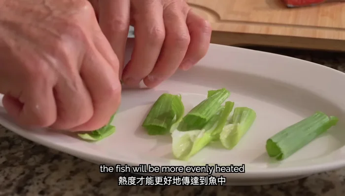 Prepare aromatics: Cut ginger and scallions into thin strips. Chop cilantro. (Use approximately 1 ounce ginger, 2 ounces green onion, 1 ounce cilantro for 1 pound salmon)