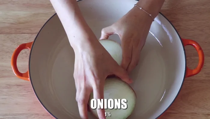 In the roasting pan, add onions, leeks, garlic, and chicken stock.