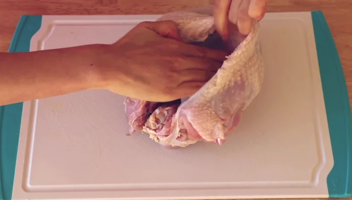 Separate the turkey skin from the breast, being careful not to tear it. Leave the edges attached to create a pocket.