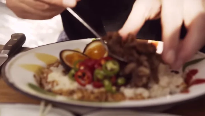 Heat the roast duck and place it on the side of the congee with the crispy chilies and sesame seeds.