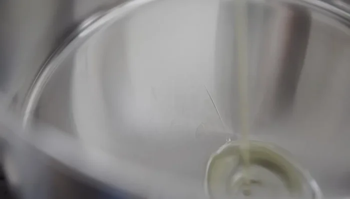 In a stockpot over medium heat, sauté the garlic in avocado oil for 2 minutes.