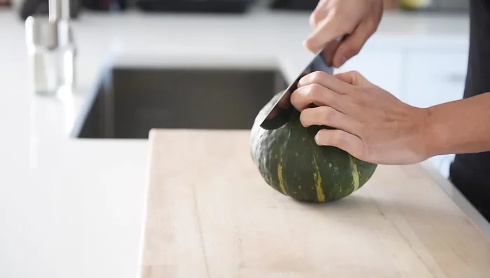 Preheat oven to 375°F (190°C). Cut a medium-sized Buttercup squash in half, scoop out the seeds, and peel the skin.