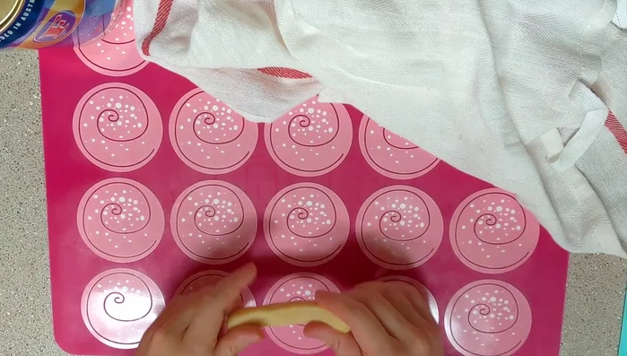 Roll one piece into a 20-inch long strand. Repeat for a second strand.