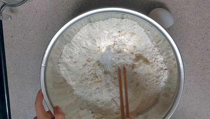 Add lukewarm water and mix with dry ingredients.