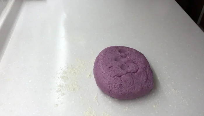 Transfer the dough to a floured surface, divide it into four big pieces, then shape each into a small ball. (185.68)