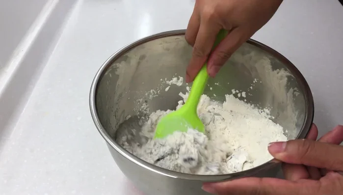 Add water and mix. Then add yeast and combine until a dough forms. (104)