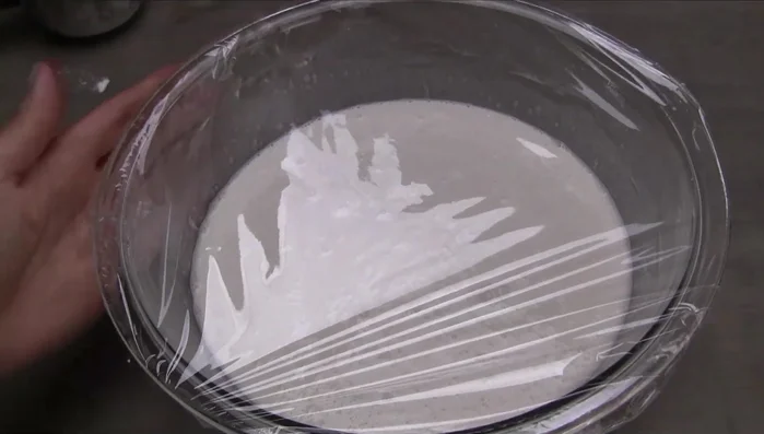 Place the bowl in a microwave or oven. Place 2 cups of boiling water next to the bowl to create heat. Cover with plastic wrap and let rest for 1.5-2 hours (or until bubbly).